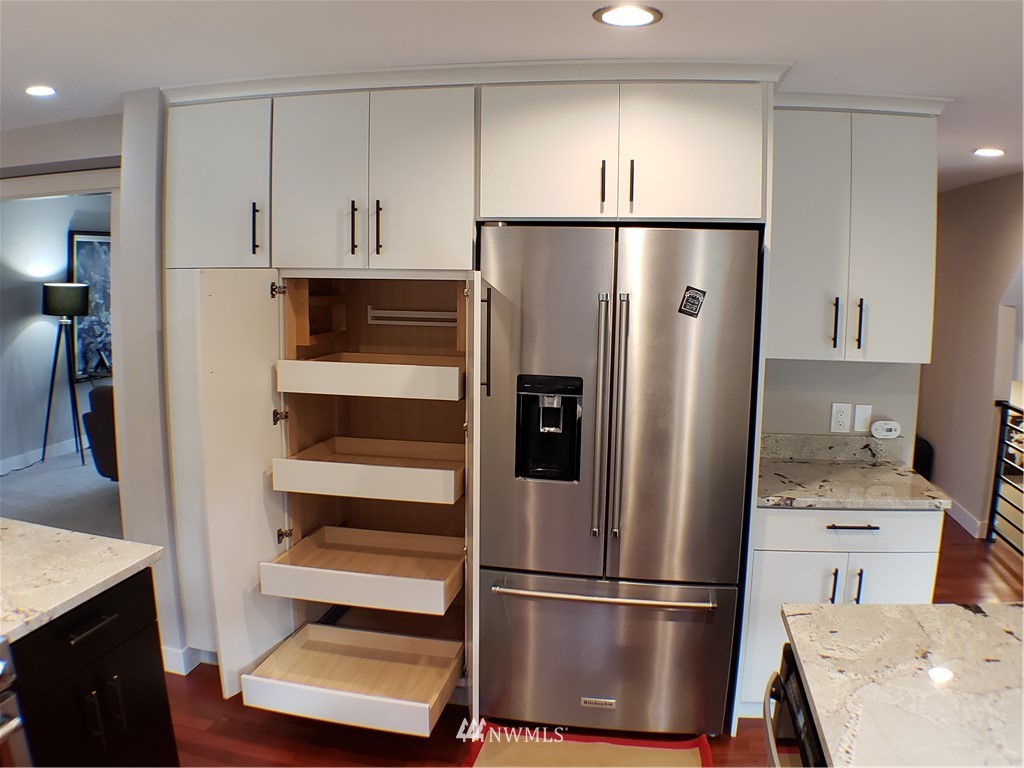 502 224 Place Southeast Bothell, WA 98021 - Photo 13 of 39 a kitchen with kitchen island a counter top space stainless steel appliances and cabinets