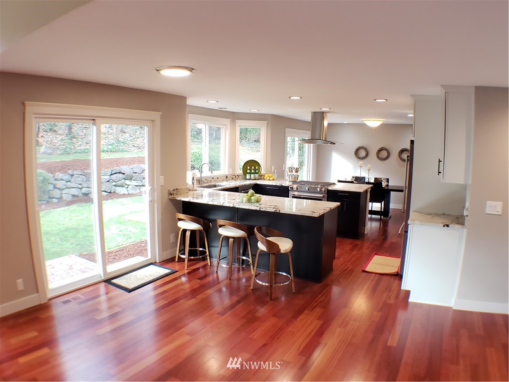 502 224 Place Southeast Bothell, WA 98021 - Photo 14 of 39 a kitchen with a sink dining table chairs and a large window