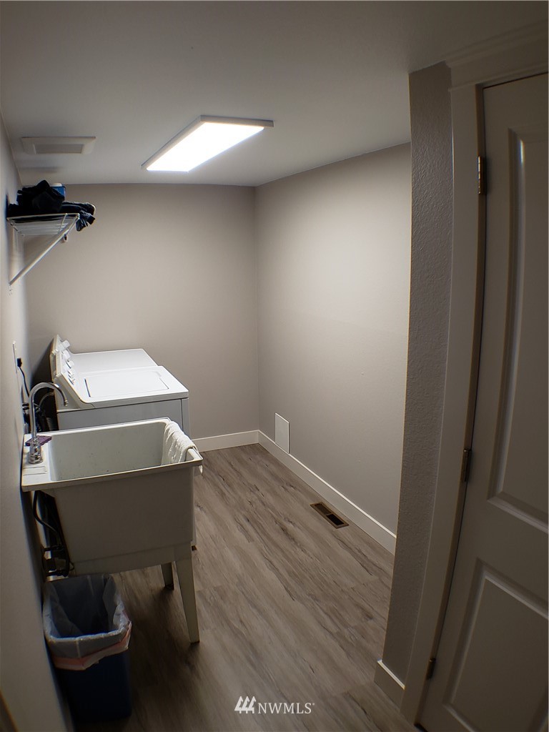 502 224 Place Southeast Bothell, WA 98021 - Photo 31 of 39 a room with a chair and wooden floor