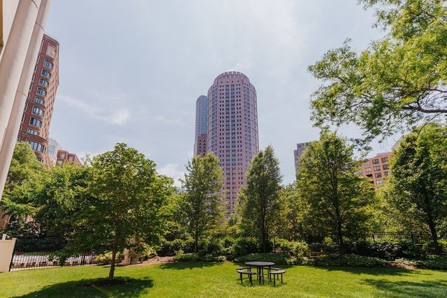 a view of a swimming pool with a bench and trees