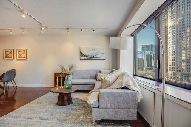 a living room with furniture and wooden floor