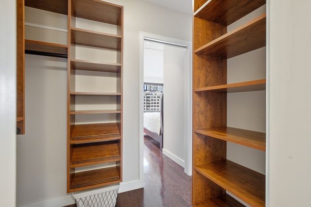 a view of walk in closet with empty racks