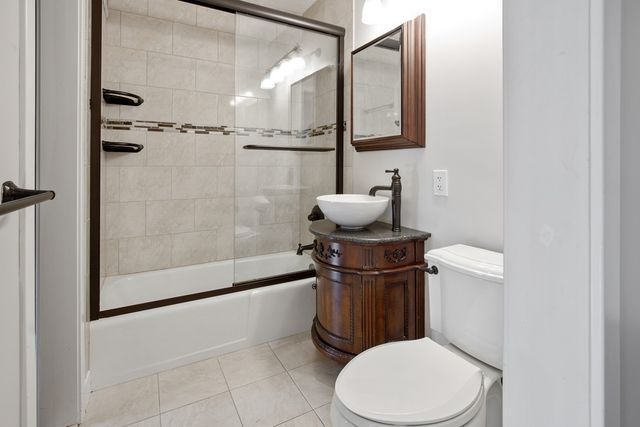 a bathroom with a toilet a sink and shower