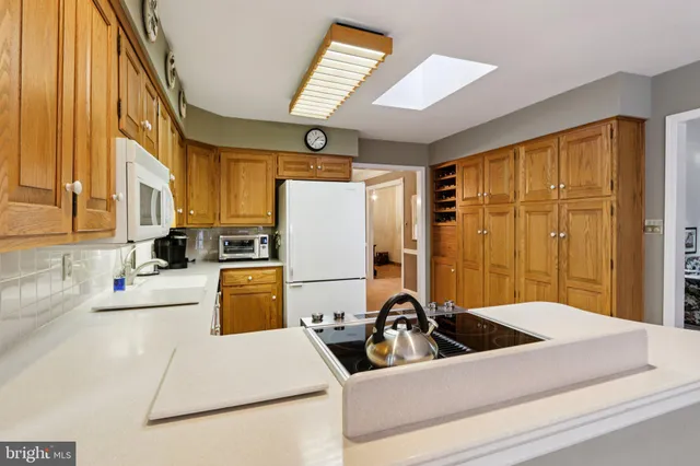 a view of a kitchen with a sink a refrigerator and a stove