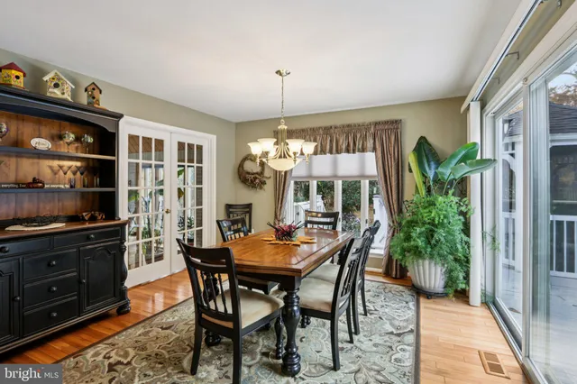 a view of a dining room with furniture and chandelier