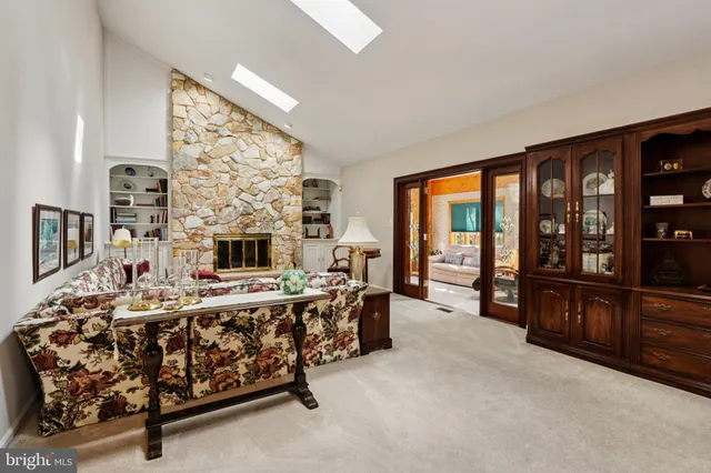 a living room with furniture large window and flat screen tv
