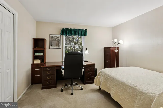 a bedroom with a workspace