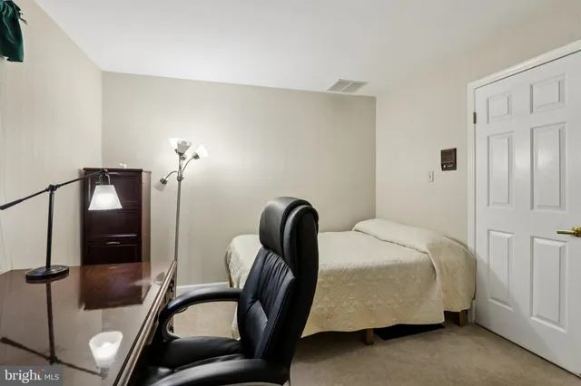 a bedroom with a bed and ceiling fan