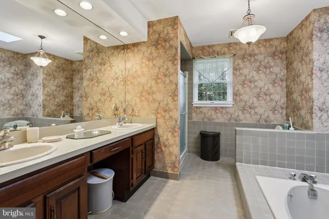 a spacious bathroom with a bathtub and sink