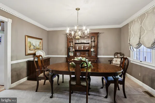 a view of a dining room with furniture and chandelier