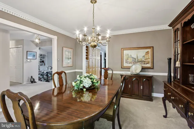 a dining room with furniture a livingroom and chandelier