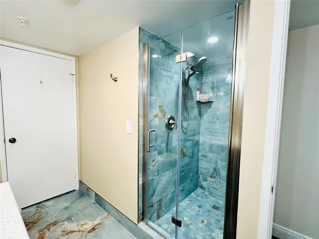 a bathroom with a shower and a sink