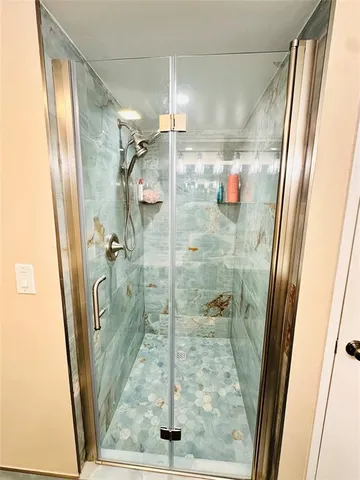 a bathroom with a shower and a sink