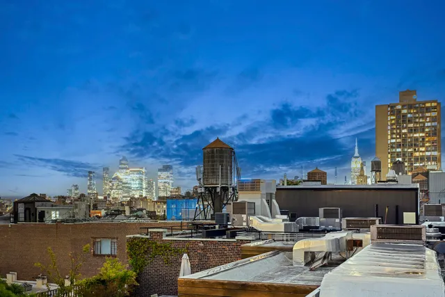 a bathroom with a toilet sink vanity and shower