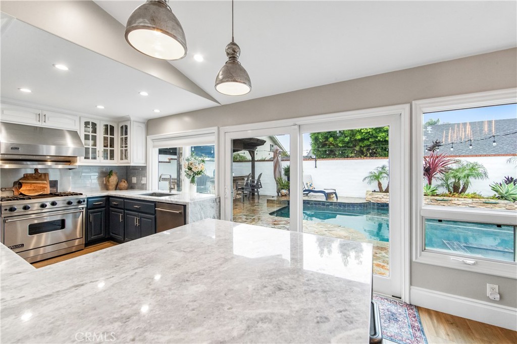 5522 Mossvale Circle Huntington Beach, CA 92649 - Photo 14 of 61 Spacious dining area with marble breakfast bar and views to the resort-style backyard