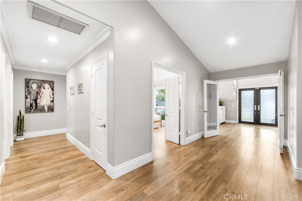 5522 Mossvale Circle Huntington Beach, CA 92649 - Photo 18 of 61 Bright connecting hallways lead to bedrooms while showcasing the striking glass entry and staircase.