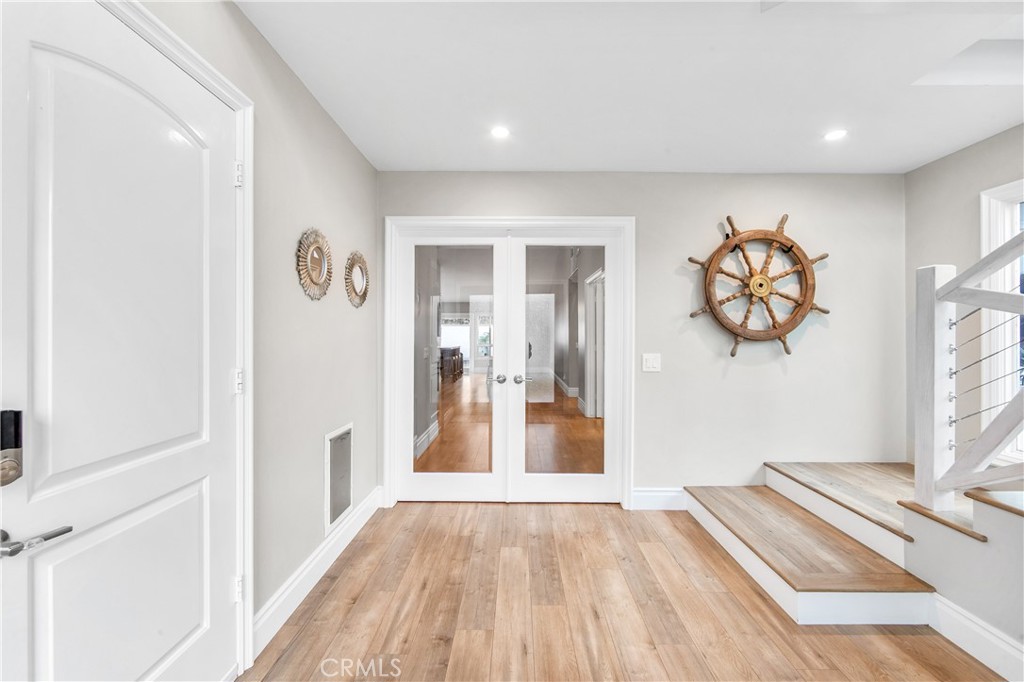 5522 Mossvale Circle Huntington Beach, CA 92649 - Photo 20 of 61 Bright connecting hallways lead to bedrooms while showcasing the striking glass entry and staircase.