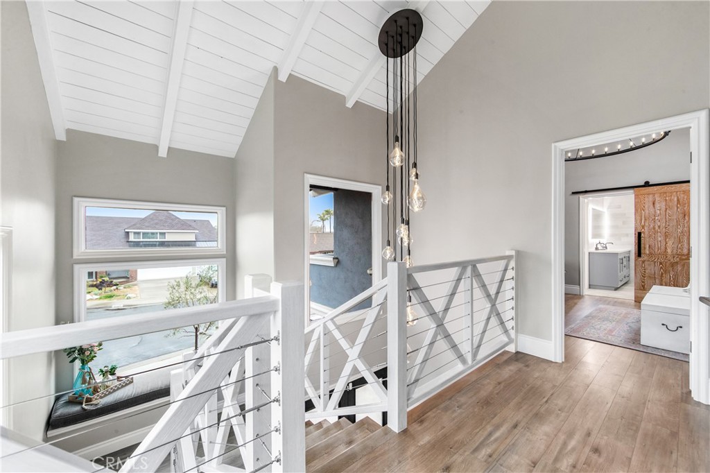5522 Mossvale Circle Huntington Beach, CA 92649 - Photo 22 of 61 Sun-drenched custom staircase with nautical-inspired railings winds to a mezzanine retreat, complete with a cozy reading nook framed by two-story windows.