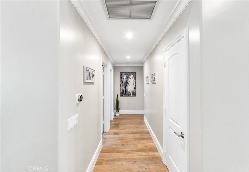 5522 Mossvale Circle Huntington Beach, CA 92649 - Photo 36 of 61 Bright central hallway connecting bedrooms and bath with clean, modern lines.