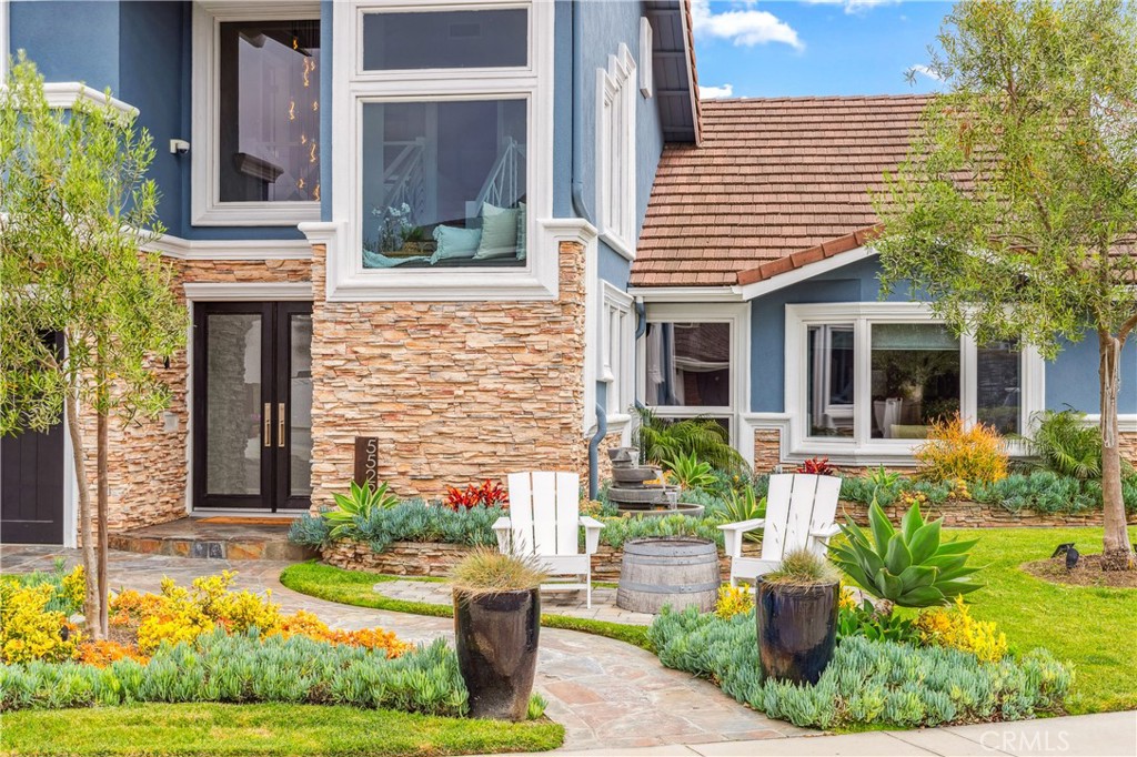 5522 Mossvale Circle Huntington Beach, CA 92649 - Photo 4 of 61 Architectural glass, stacked stone, and manicured flagstone entry.