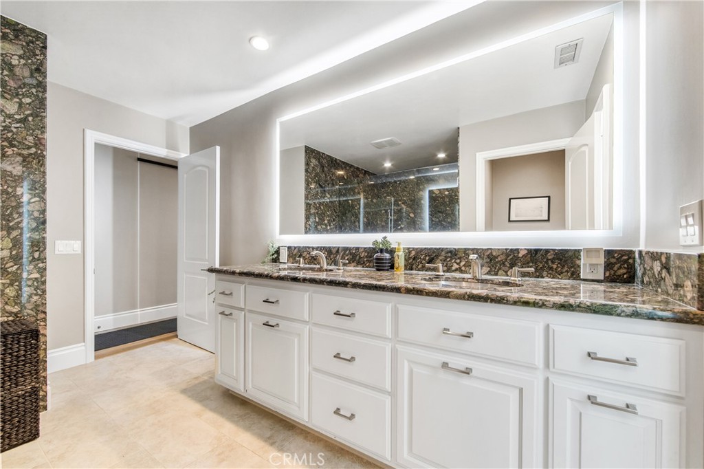 5522 Mossvale Circle Huntington Beach, CA 92649 - Photo 41 of 61 Oversized ground-floor suite with poolside access, private bath, and seamless connection to outdoor shower and resort yard.