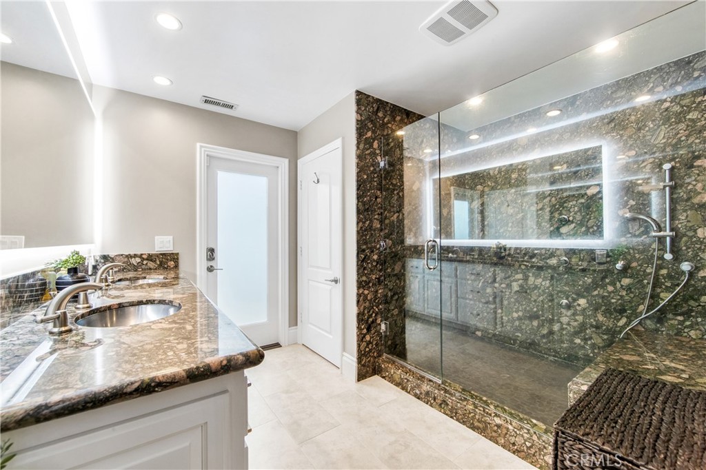 5522 Mossvale Circle Huntington Beach, CA 92649 - Photo 43 of 61 Oversized ground-floor suite with poolside access, private bath, and seamless connection to outdoor shower and resort yard.