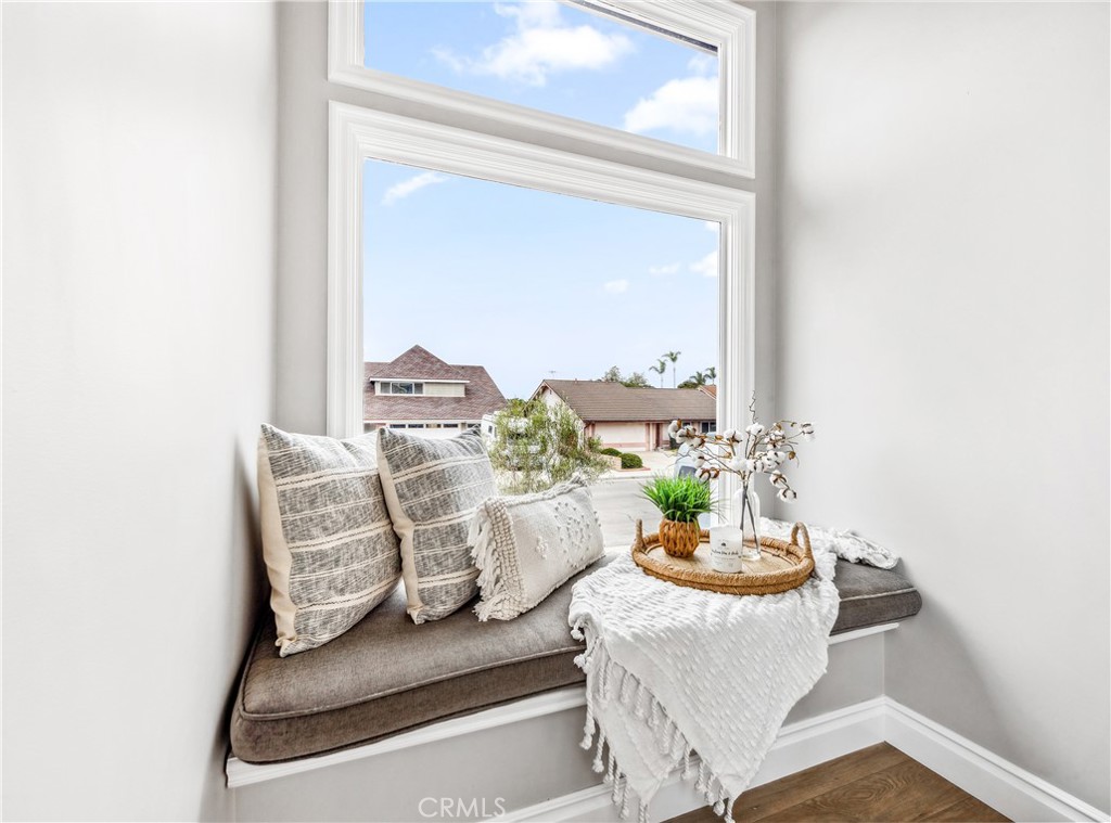 5522 Mossvale Circle Huntington Beach, CA 92649 - Photo 54 of 61 Sunlit window seat offers a cozy reading nook within the bright stairwell.