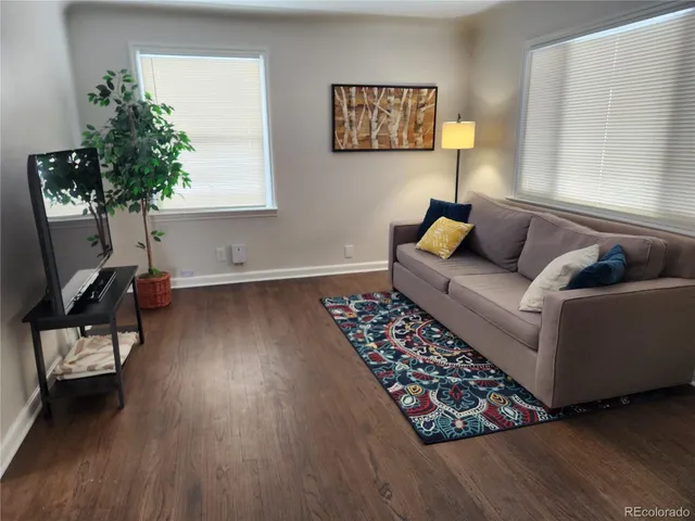 a living room with furniture and a potted plant