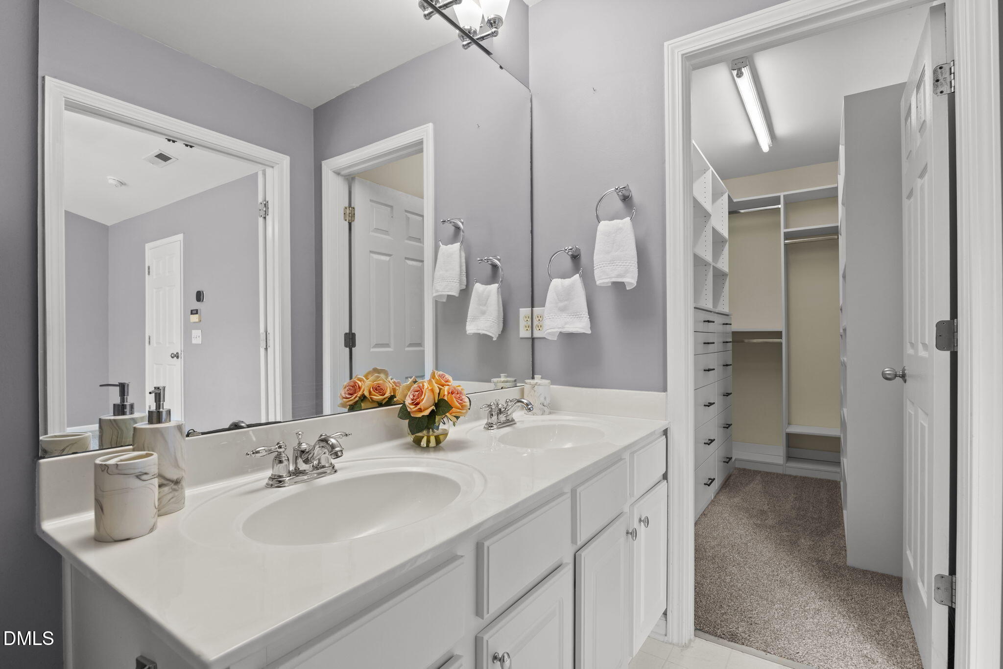 5537 Red Robin Road Raleigh, NC 27613 - Photo 16 of 33 a bathroom with a sink double vanity and a mirror