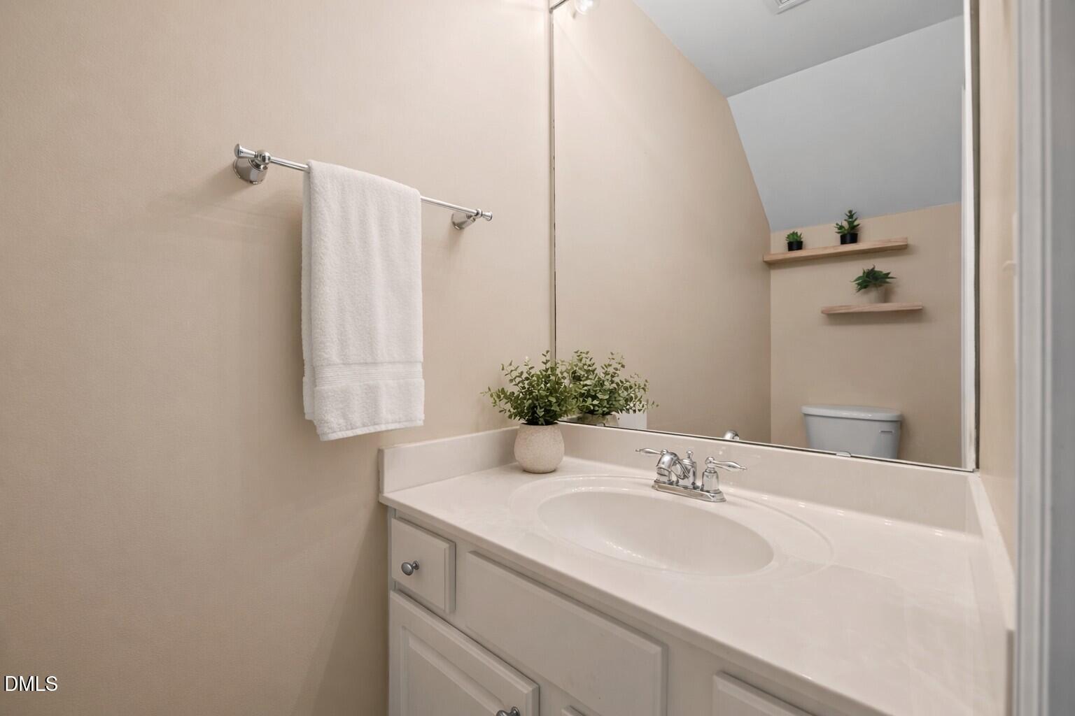 5537 Red Robin Road Raleigh, NC 27613 - Photo 24 of 33 a bathroom with a sink and a mirror