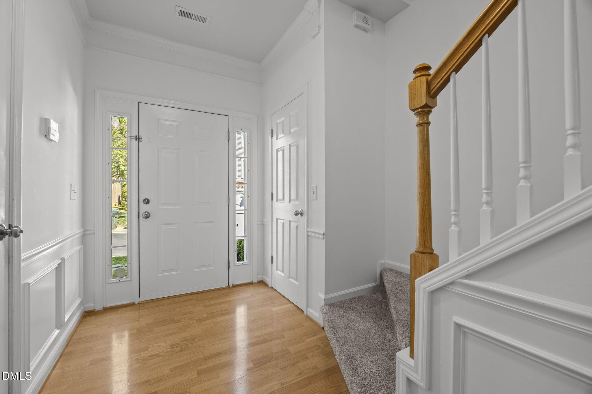 5537 Red Robin Road Raleigh, NC 27613 - Photo 4 of 33 a view of a hallway with wooden floor and entryway