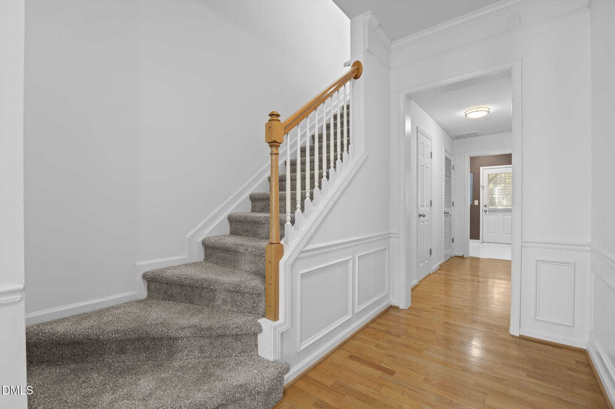 5537 Red Robin Road Raleigh, NC 27613 - Photo 5 of 33 a view of staircase with wooden floor and fan