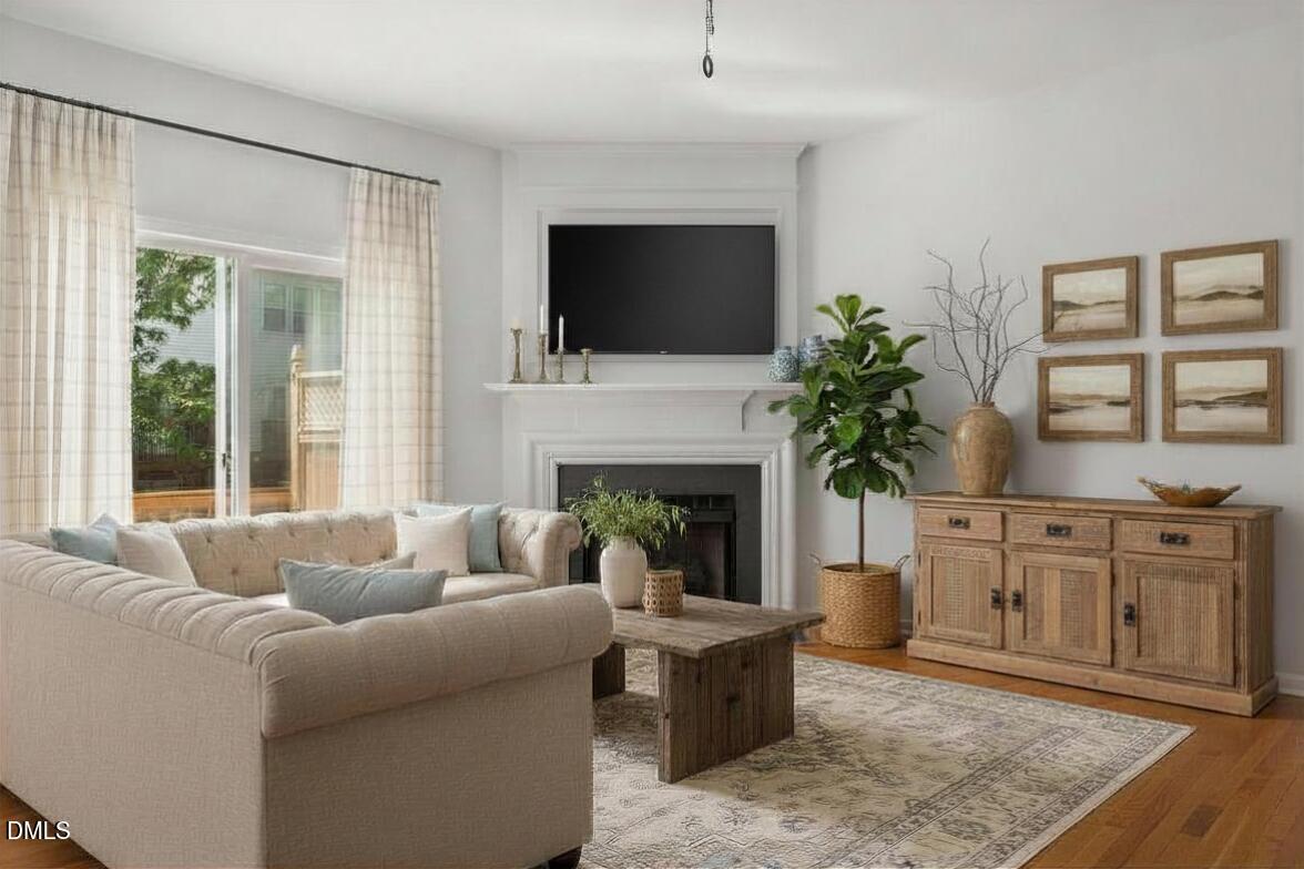 5537 Red Robin Road Raleigh, NC 27613 - Photo 6 of 33 a living room with furniture a flat screen tv and a fireplace