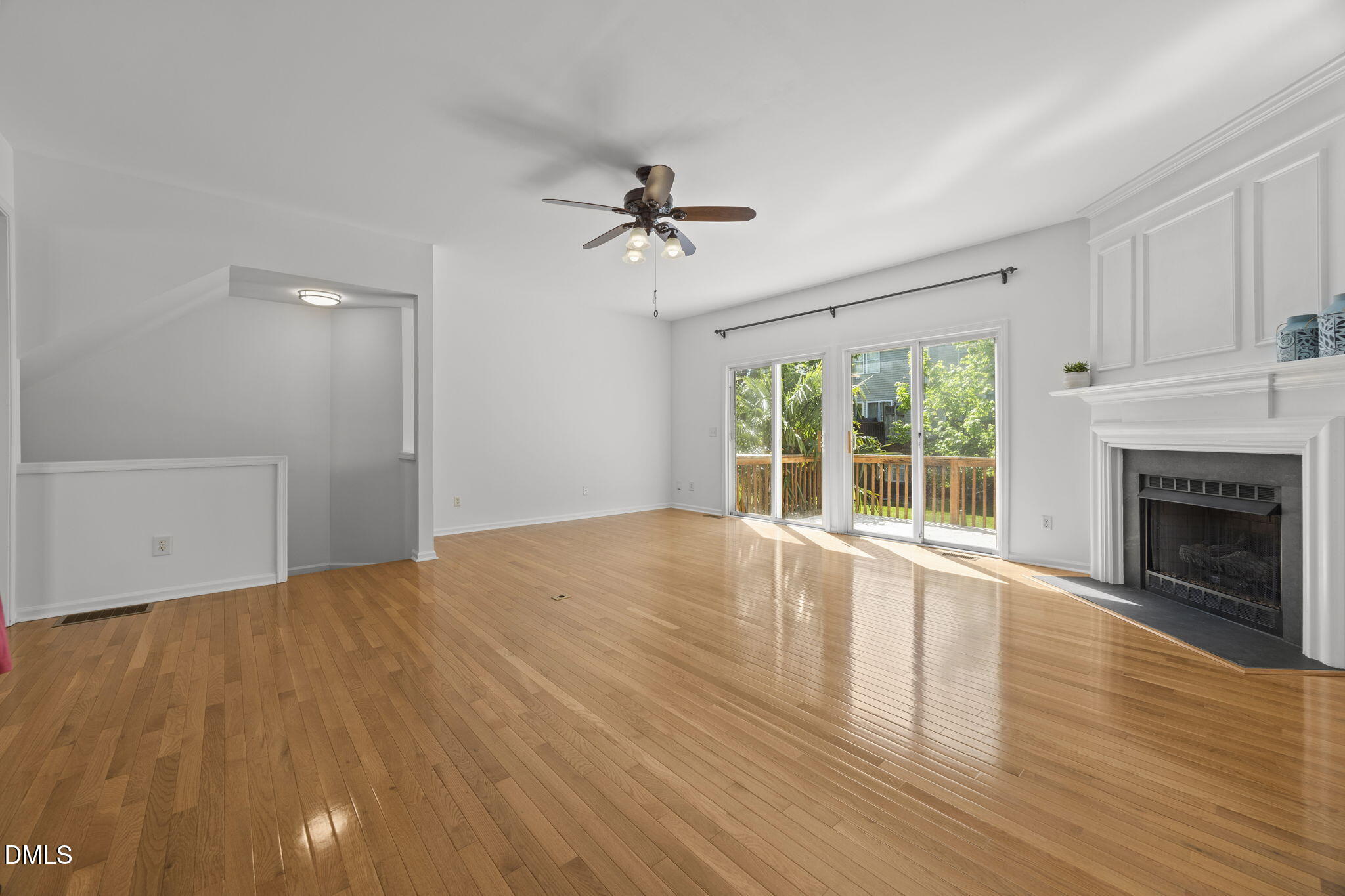 5537 Red Robin Road Raleigh, NC 27613 - Photo 8 of 33 a view of empty room with wooden floor and fireplace