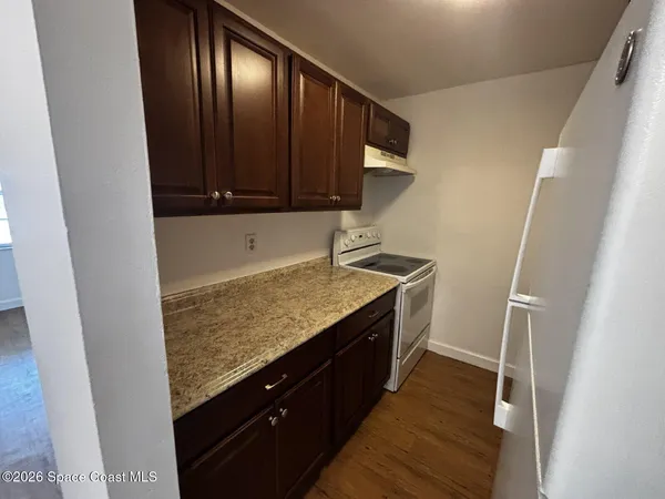 a kitchen with granite countertop cabinets and black appliances