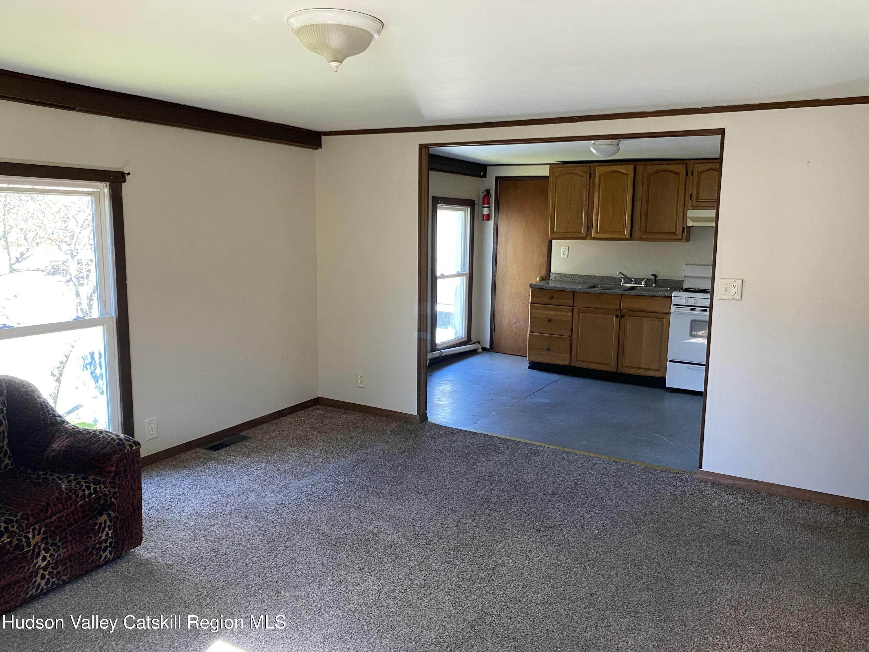 53654 Highway 30 Roxbury, NY 12474 - Photo 12 of 18 a view of an empty room with a window and kitchen view