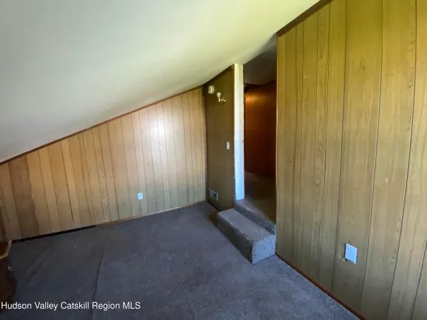 a view of an empty room with wooden walls