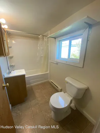 a bathroom with a toilet a sink and a mirror