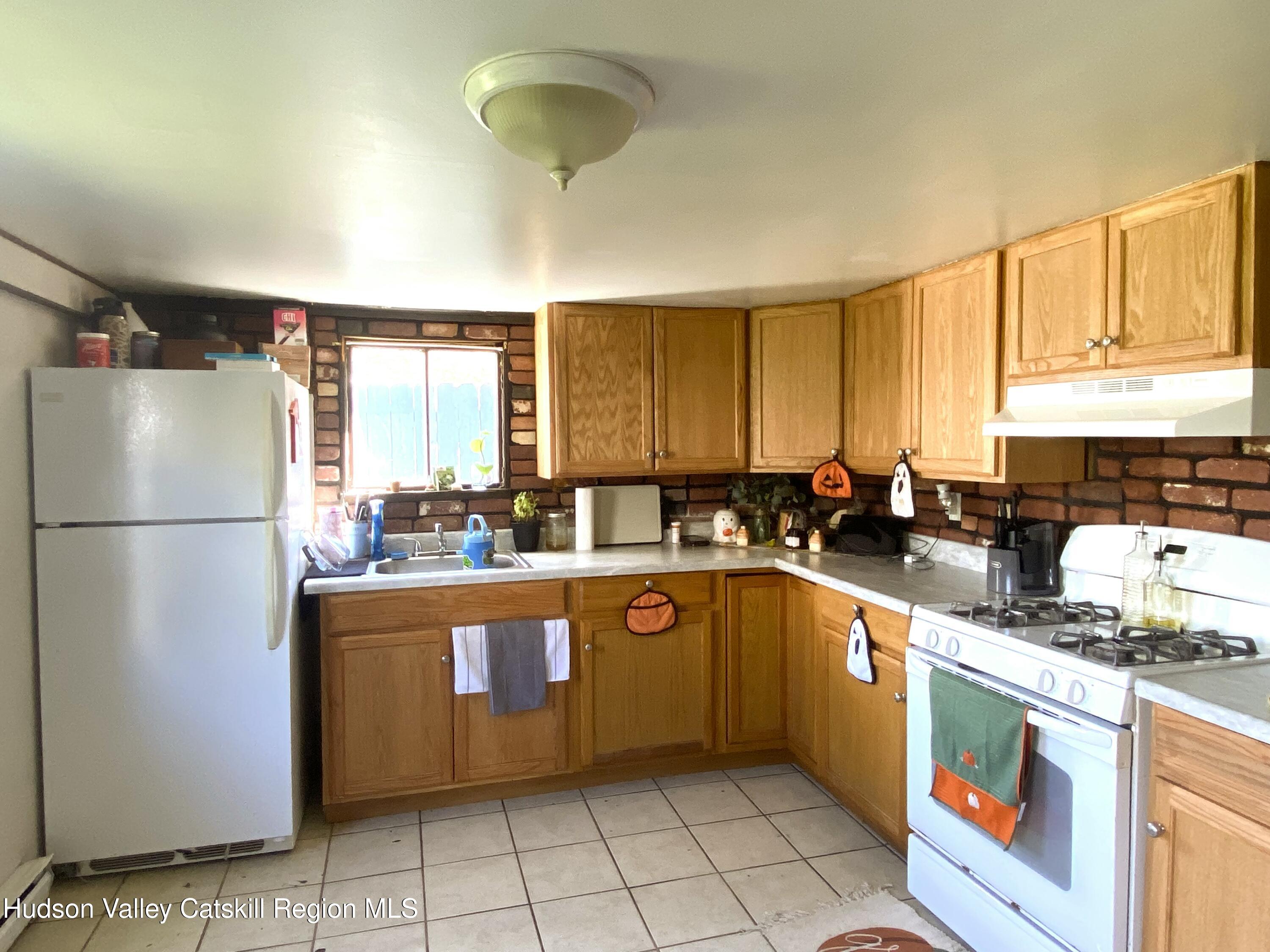 53654 Highway 30 Roxbury, NY 12474 - Photo 4 of 18 a kitchen with stainless steel appliances granite countertop a refrigerator a sink dishwasher a stove with wooden cabinets