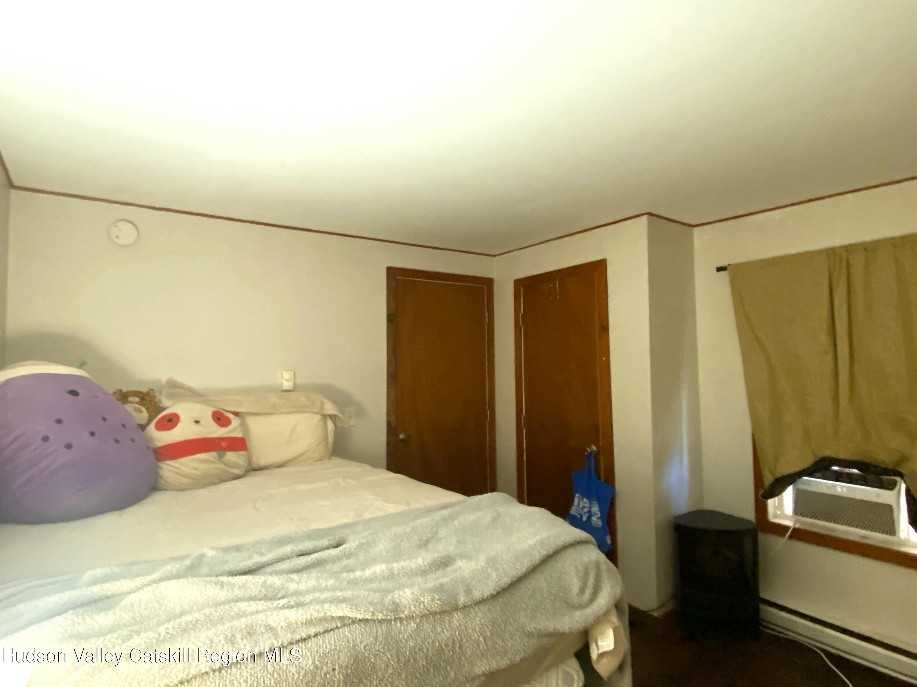 53654 Highway 30 Roxbury, NY 12474 - Photo 8 of 18 a bedroom with a bed and wooden floor