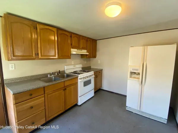 a kitchen with a refrigerator sink and cabinets