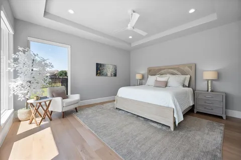 a bedroom with a bed and wooden floor