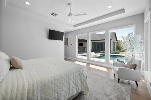 a bedroom with a bed and glass door