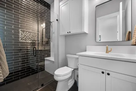 a bathroom with a sink toilet and shower