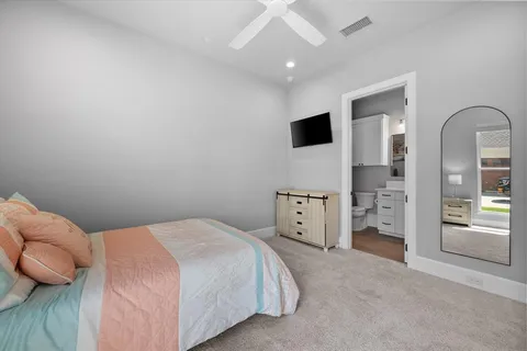 a bedroom with a bed and a television