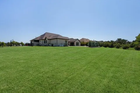 a view of a garden with a building in the background
