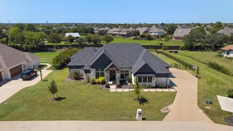 an aerial view of a house with garden space and street view