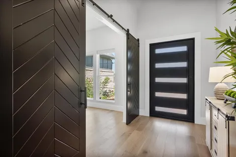 a view of an empty room with closet and a window