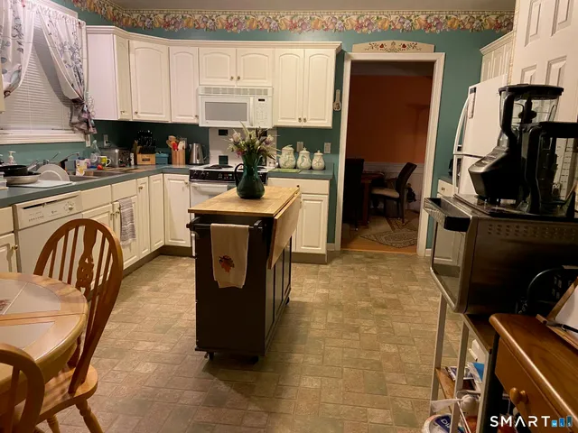 a kitchen with a sink appliances and cabinets