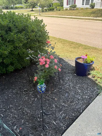 a dining room with furniture and painting on the wall